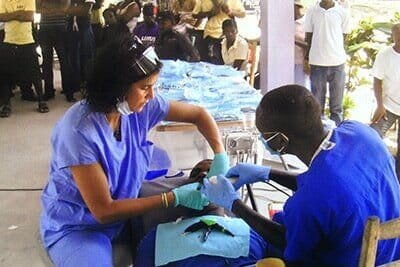 Volunteers providing dental care to a patient in Haiti